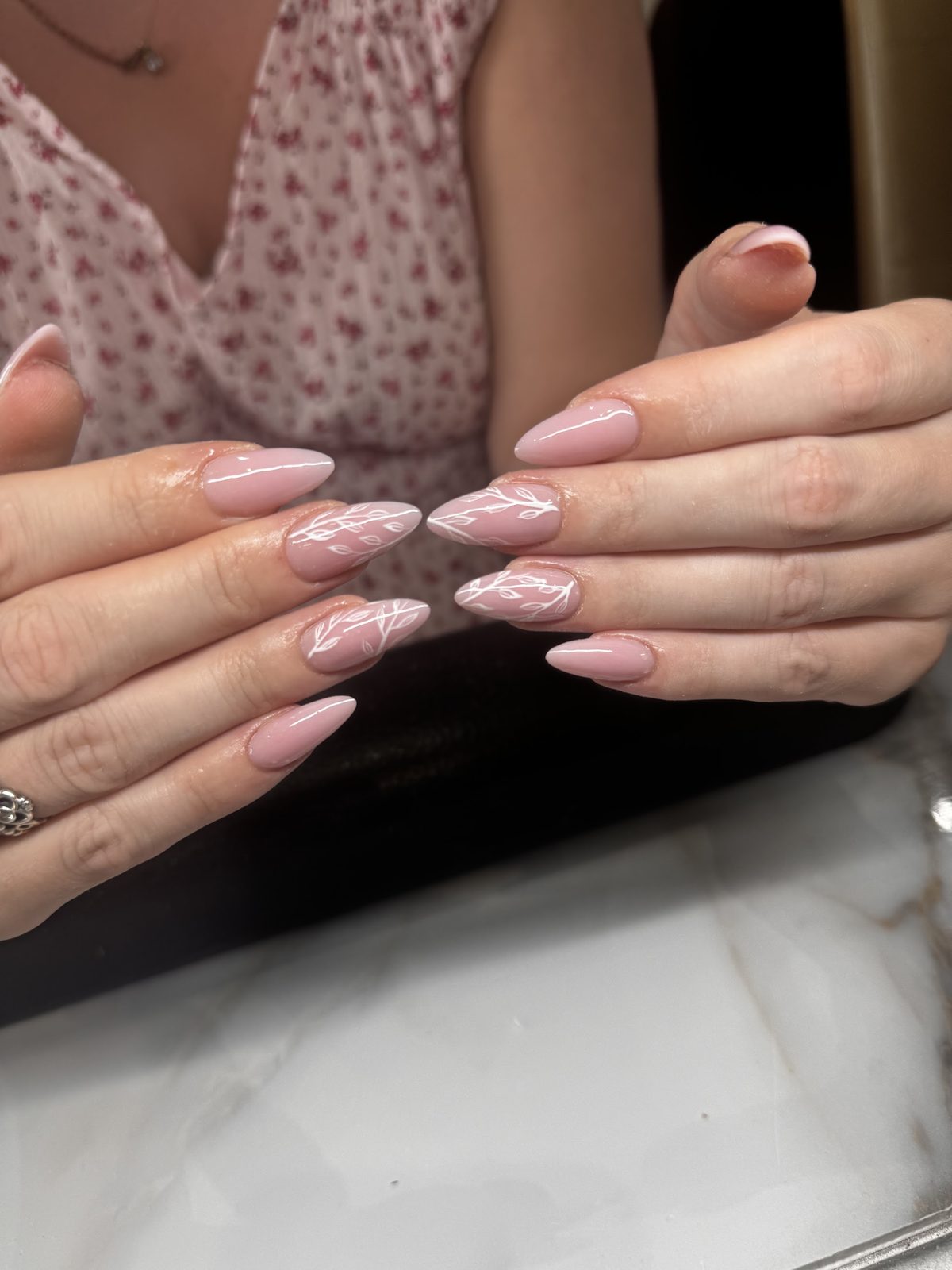 Long nude almond nails with a fine white swirl