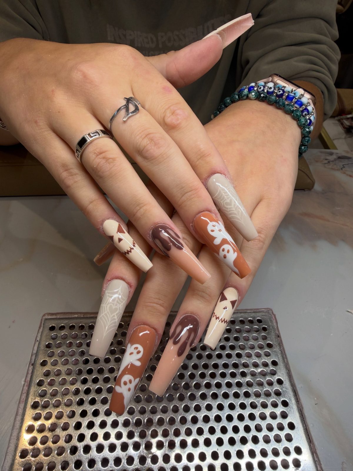 Long coffin nails in browns and cream with little ghost art